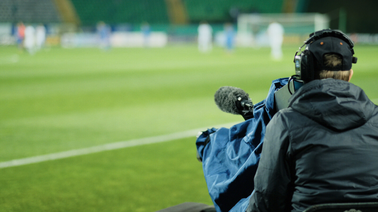 Cameraman broadcasting match from stadium