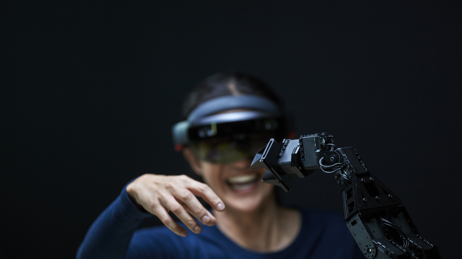 Woman using AR with robotic arm