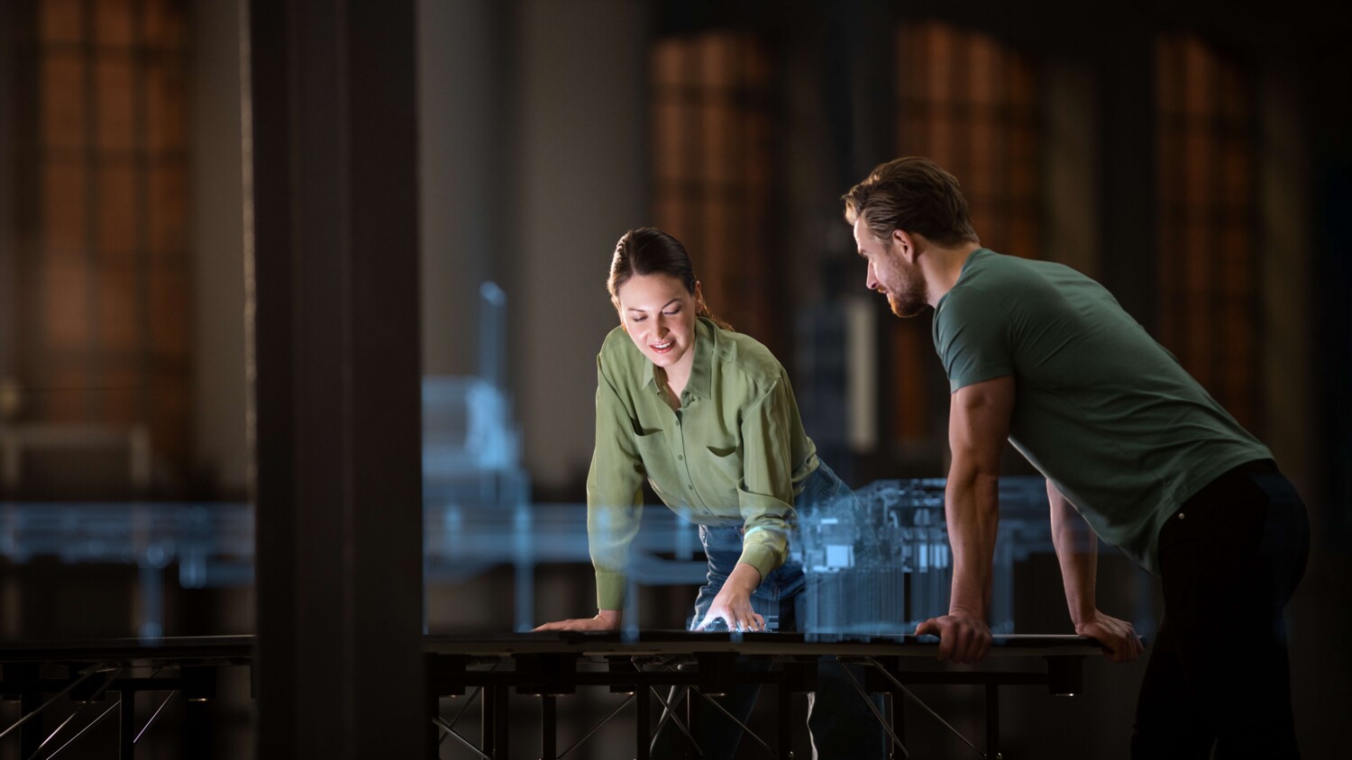 Colleagues discussing 5G industry project using a holographic model of a digital twin