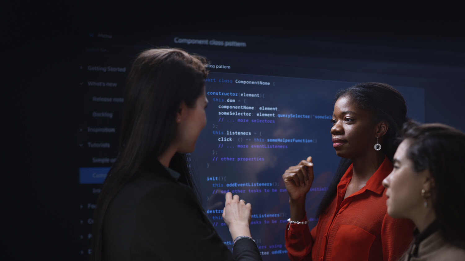 Women discussing code with digital background