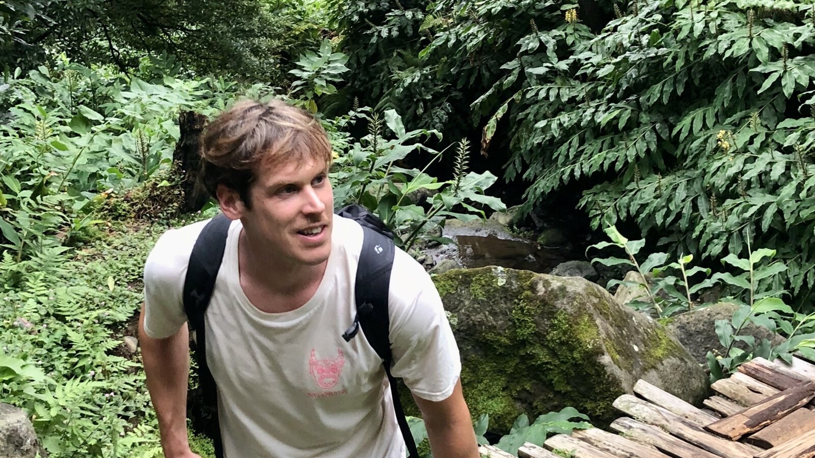 Dominik Brodschelm hiking in a forest.