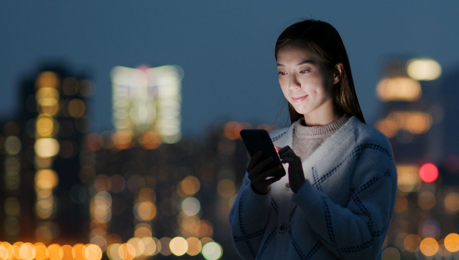 woman using her mobile device outdoors.