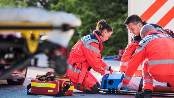 Paramedics with patient and equipment.