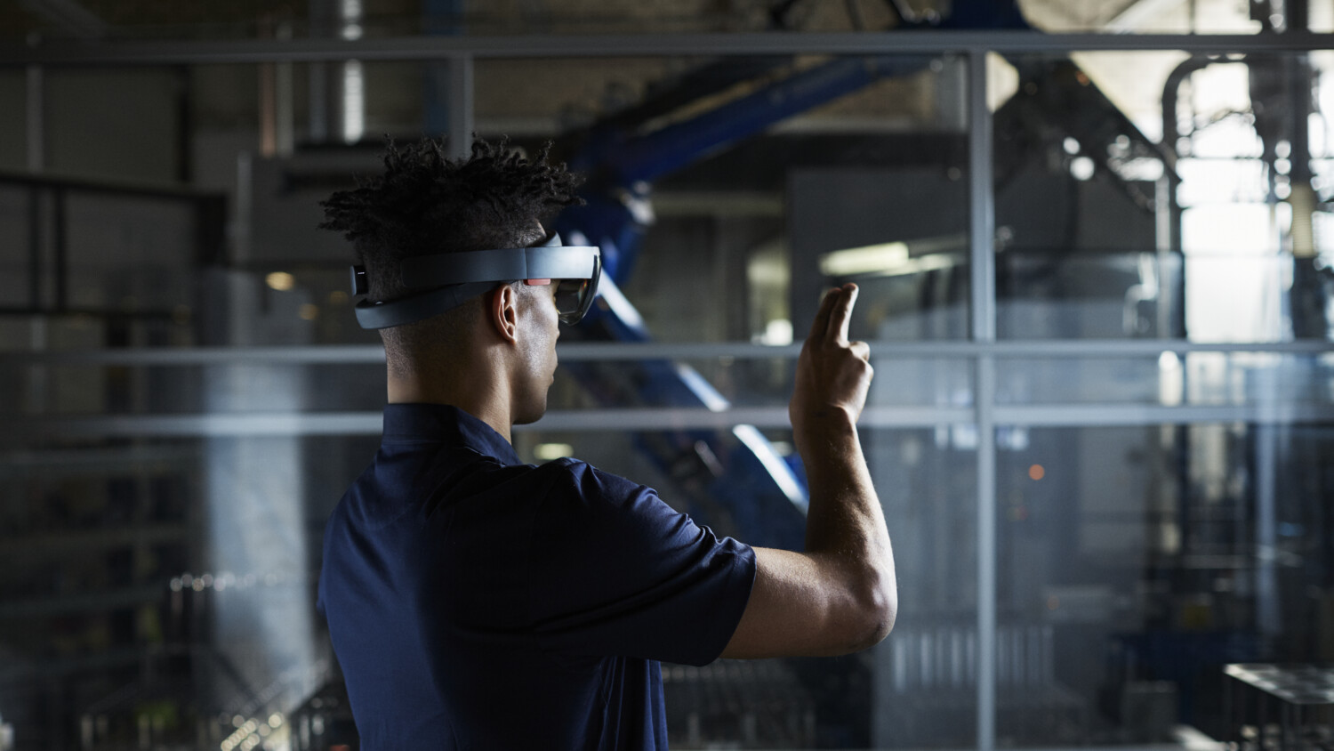 man working with VR glasses in a factory