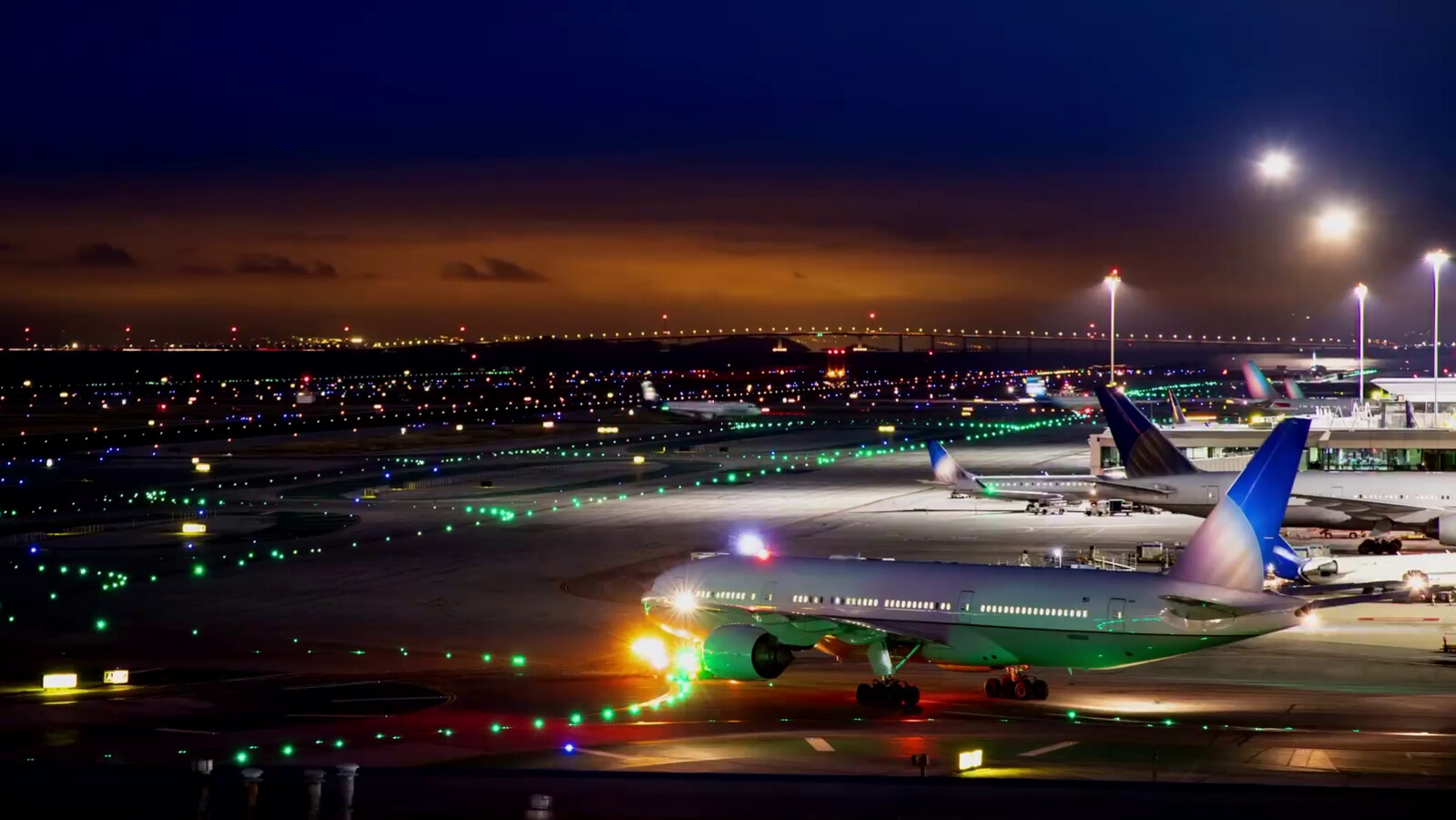 Airport with airplanes at dusk.