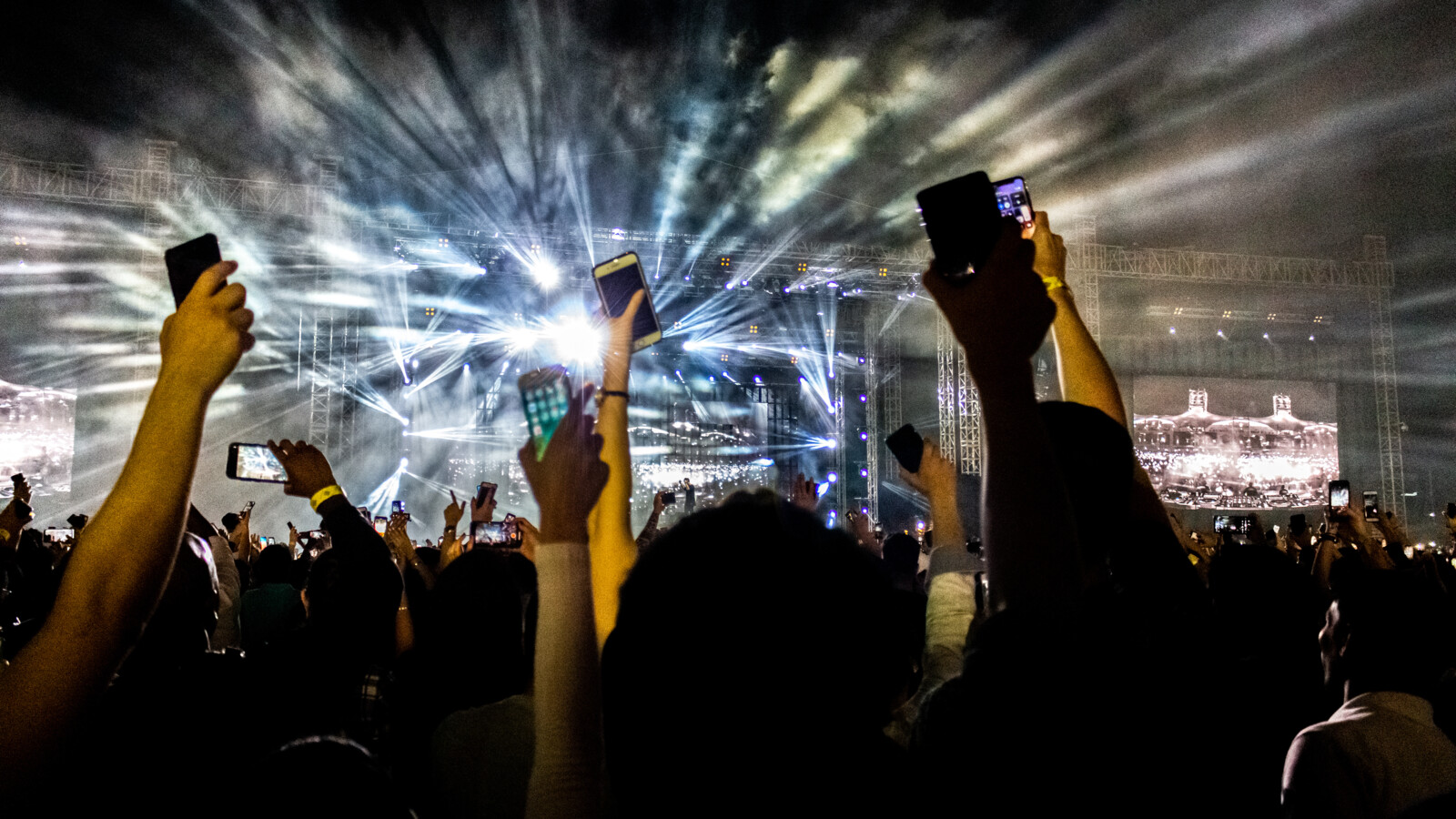 Concert audience recording with phones under stage lights