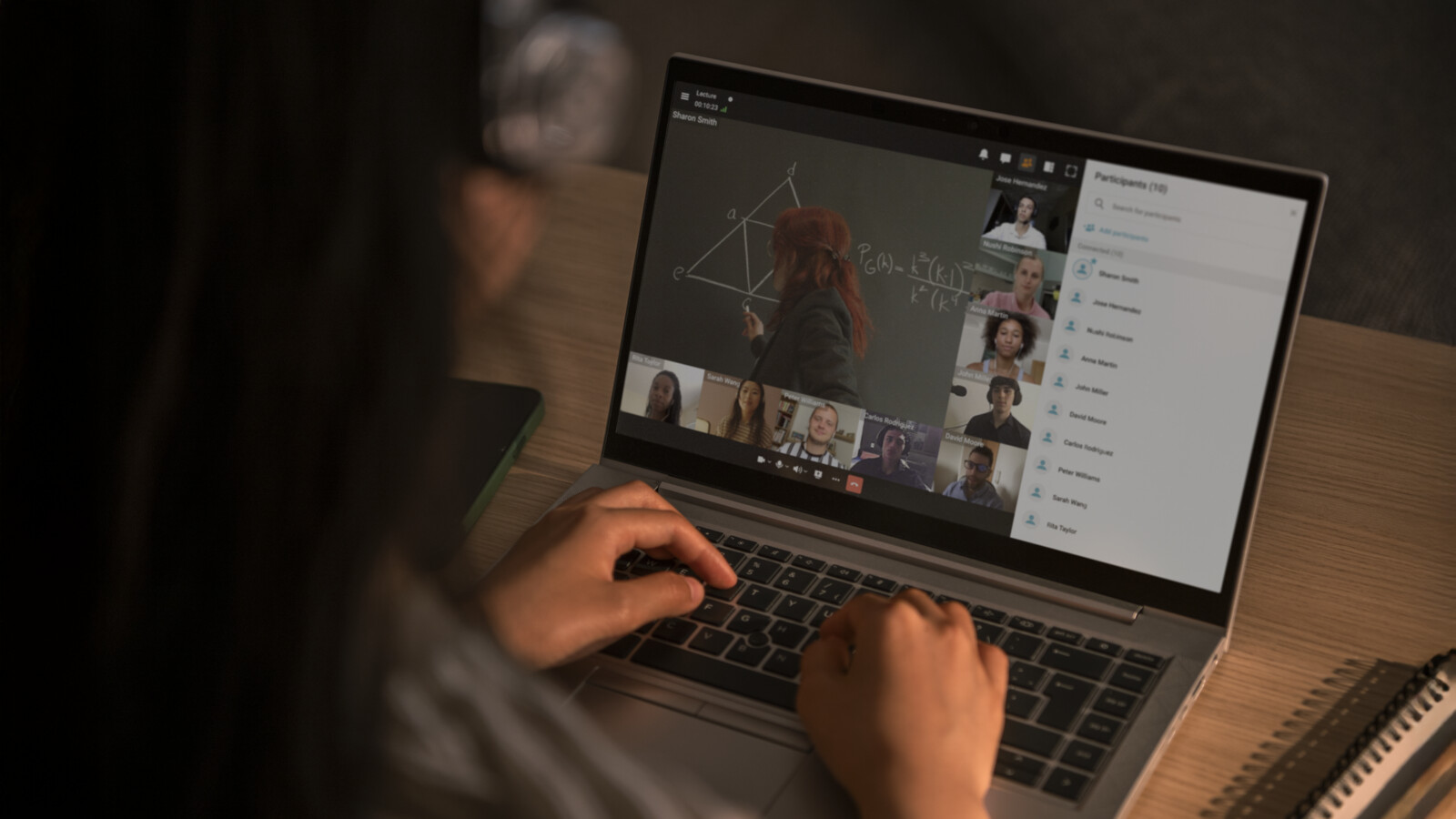 Person attending video call on laptop