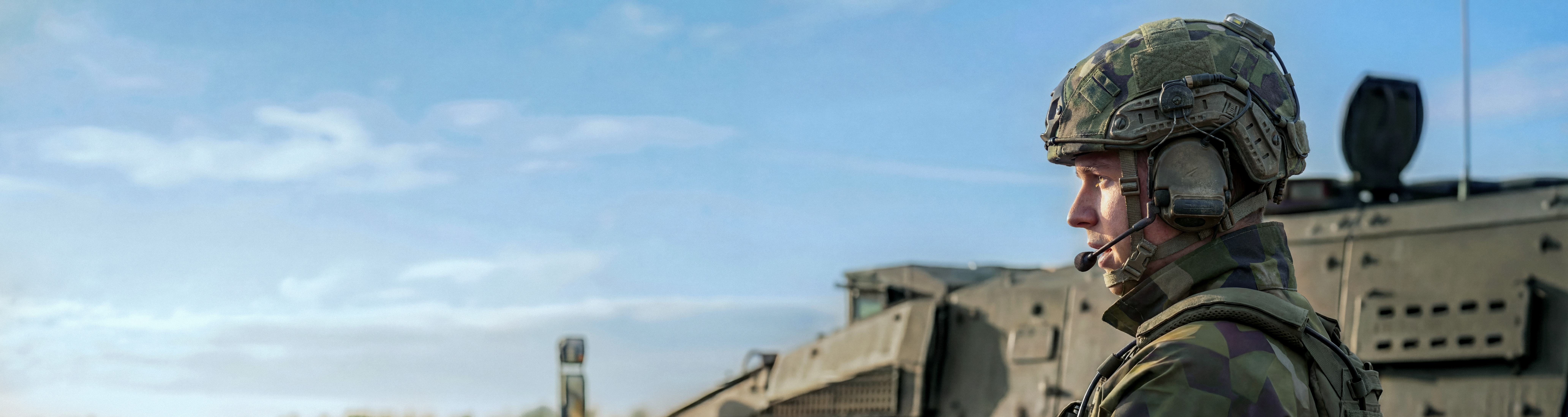 soldier next to an armed vehicle