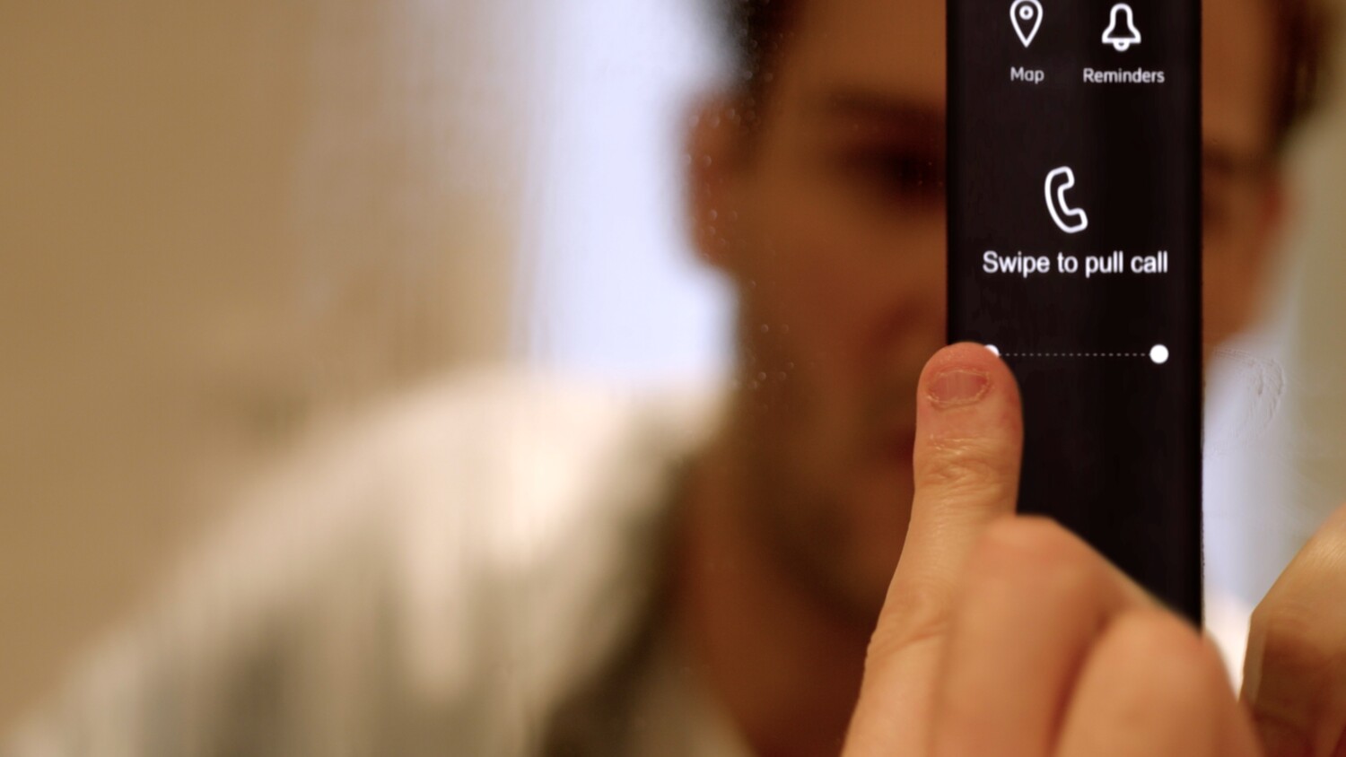 Touching a smart mirror to answer a phone call