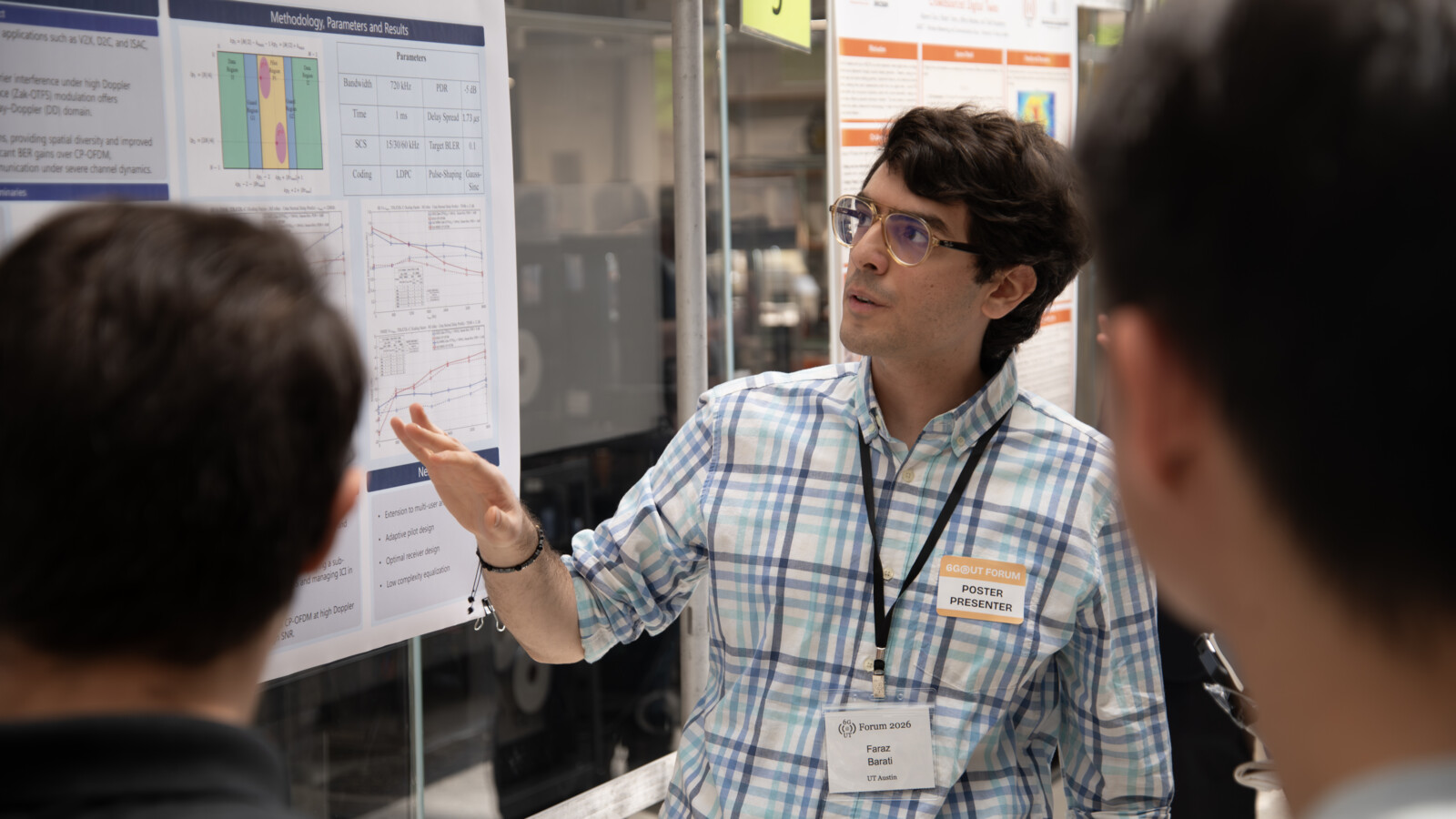 Graduate students discussing 6G research posters at the 6G@UT Forum hosted by UT Austin