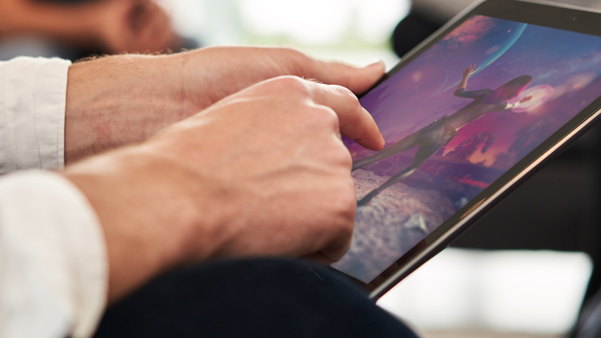 Person gaming on tablet.