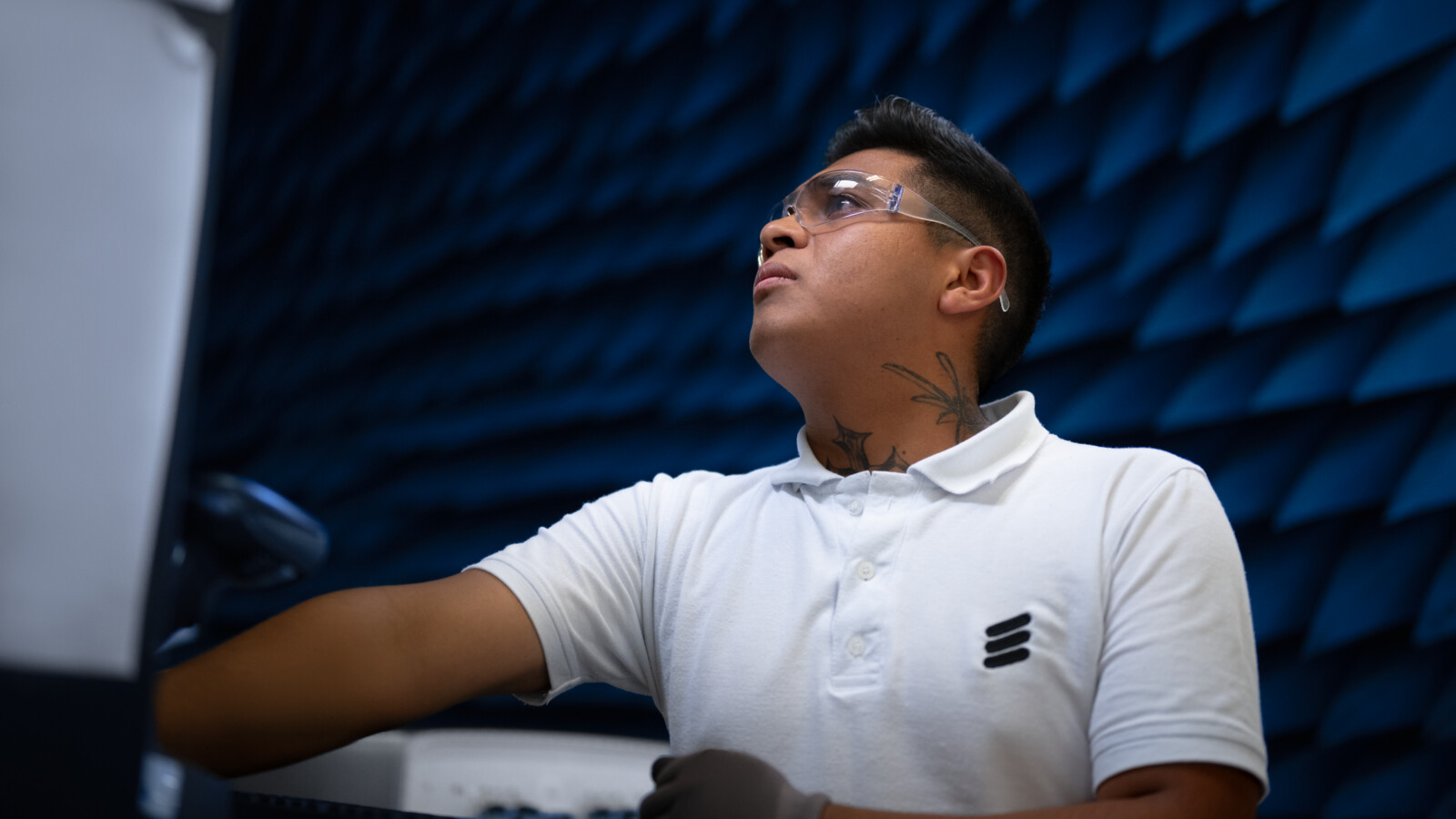 A man working with an antenna in factory
