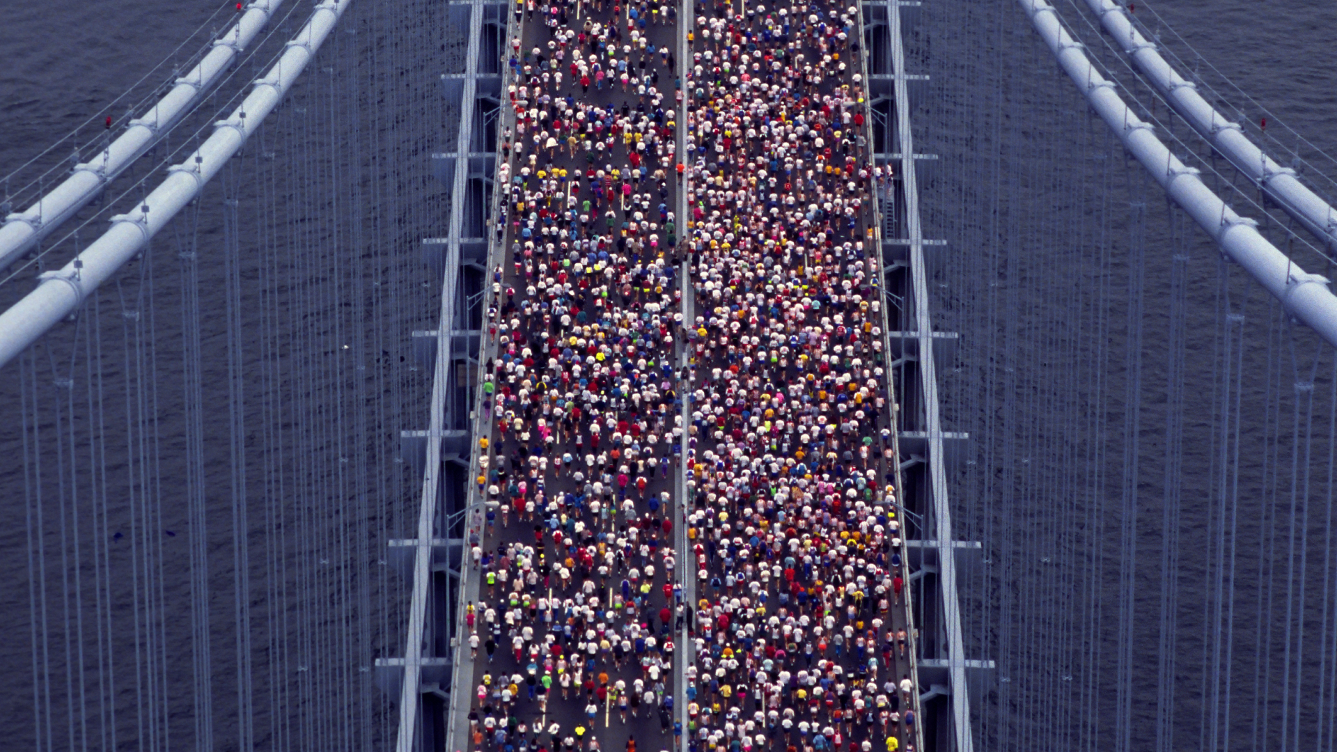 Aerial view of New York City marathon race across Verrazano bridge.