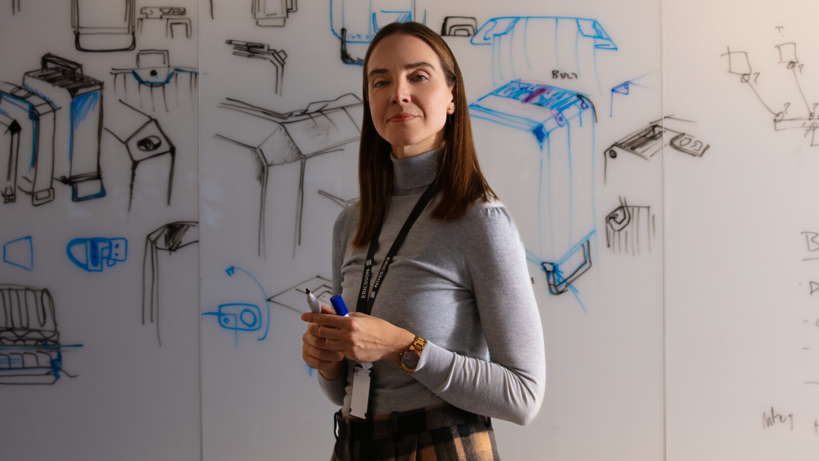 A young woman stranding in front of a whiteboard