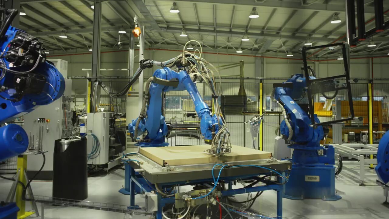 Robotic arms working in an assembly line