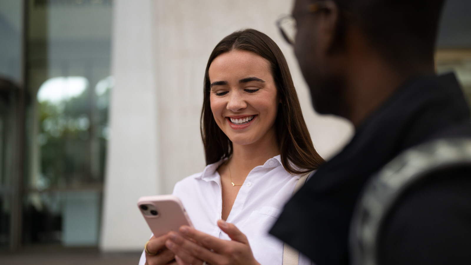 A woman smiling holding phone