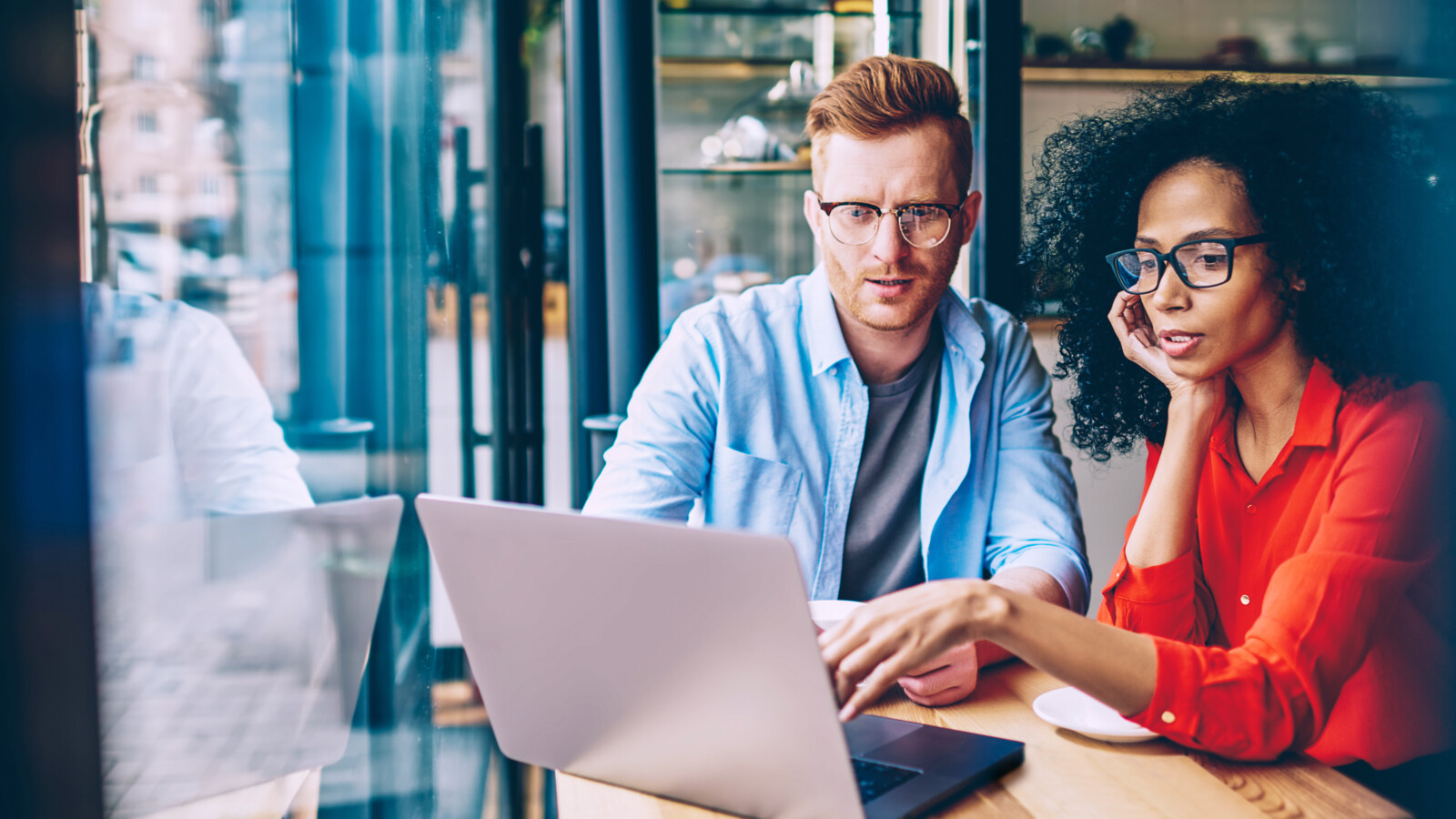 Young woman explains task for business partner