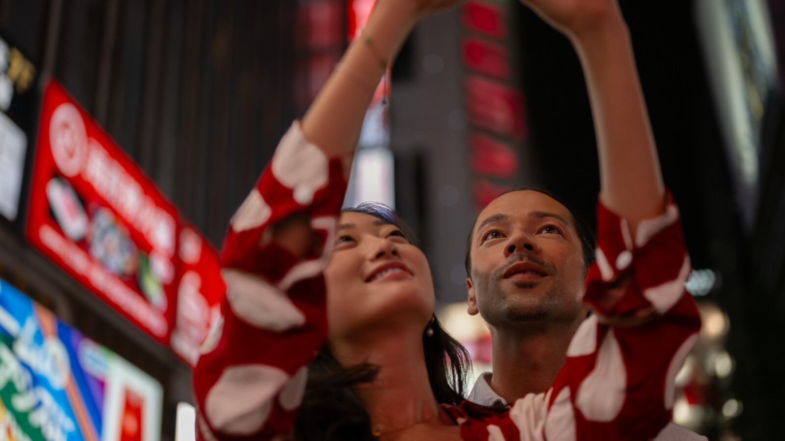 A man and woman taking a selfie in the city