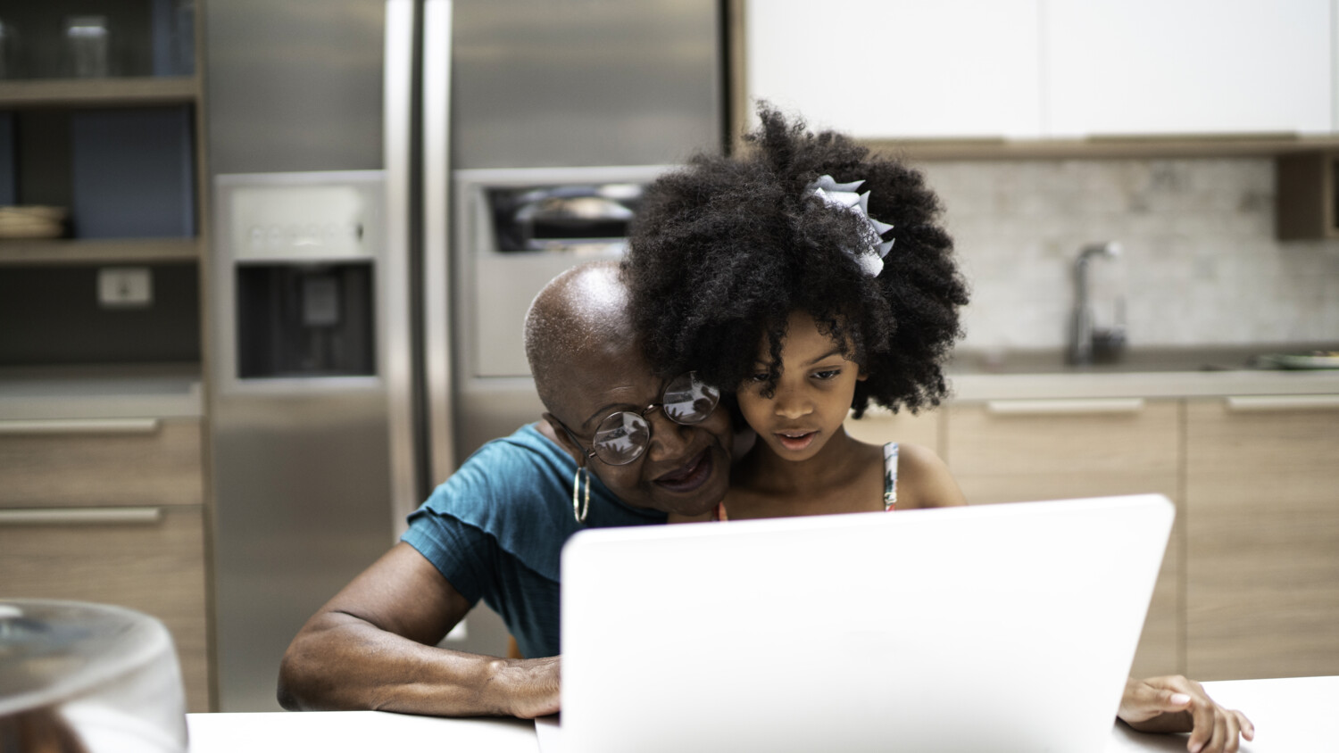 Grandma and grandchild in front of a laptop