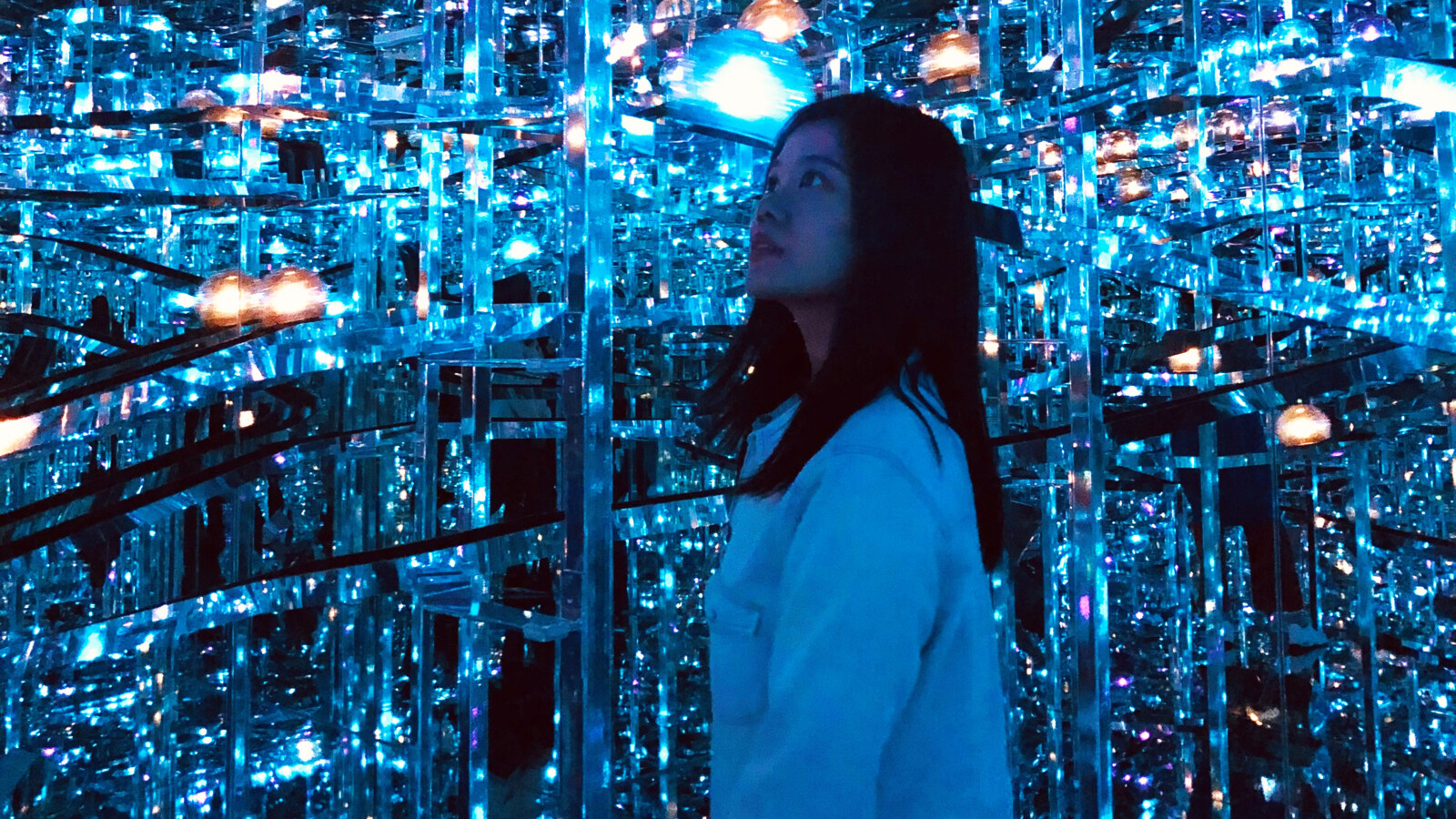A woman looking at the interactive light installations