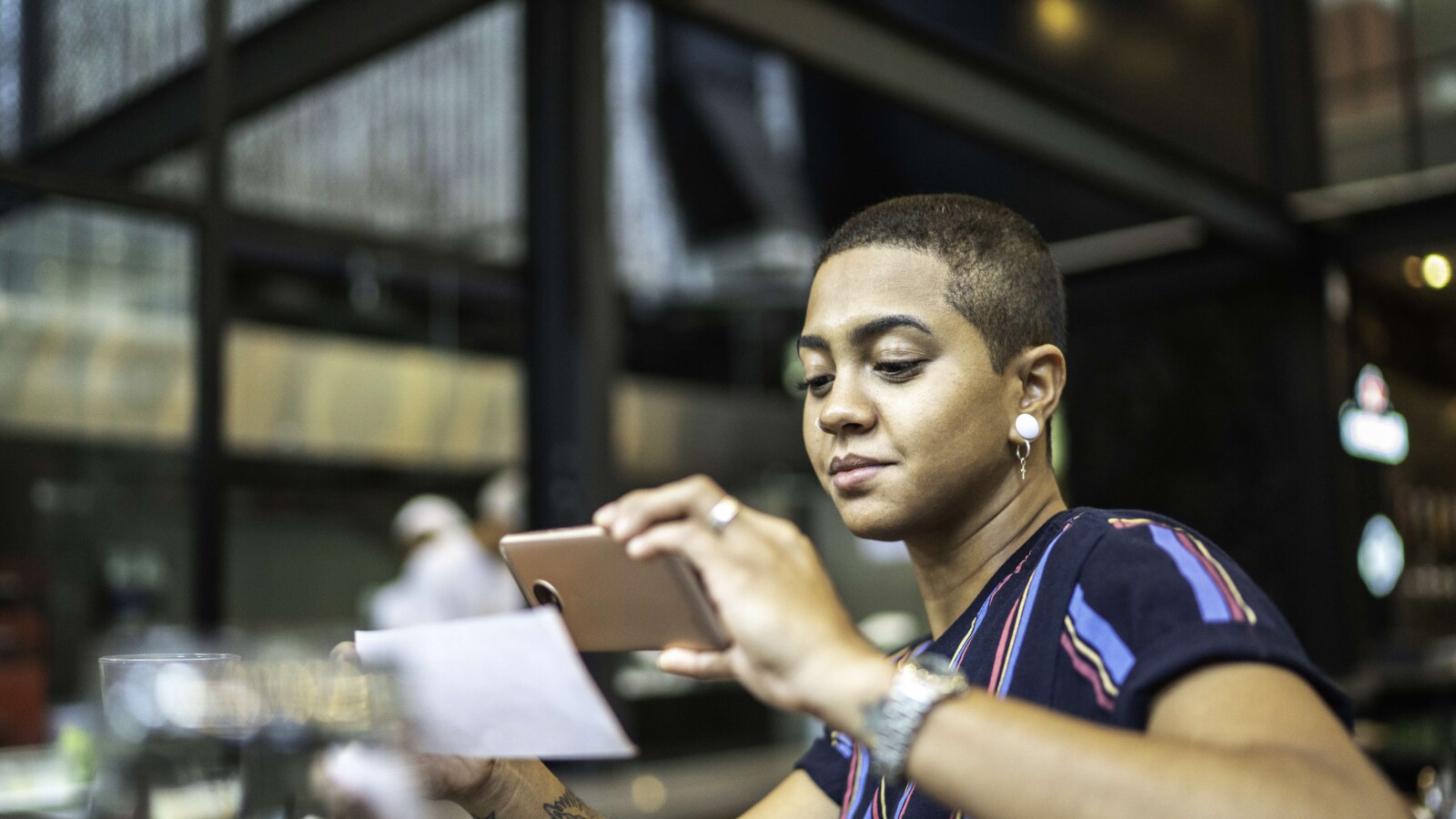 Young woman using her mobile for payment