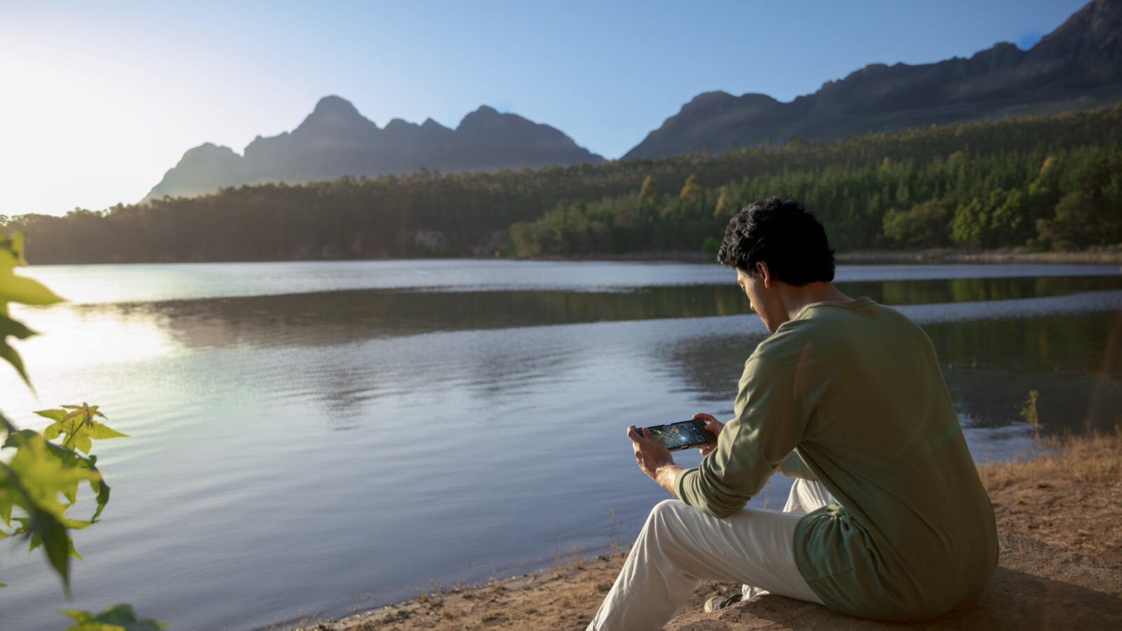 A man playing a game over 5G on his phone