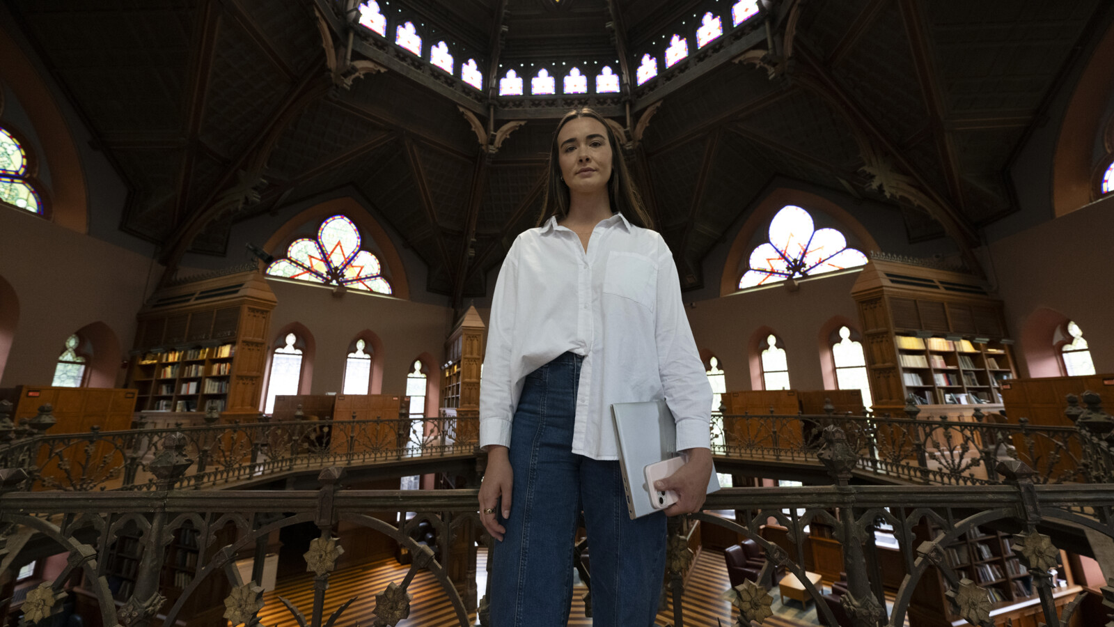 A woman inside a building with a laptop