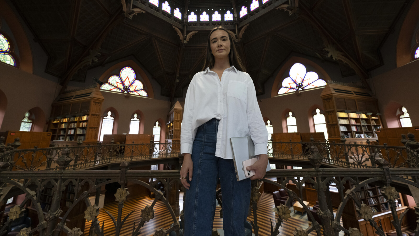 A woman inside a building with a laptop