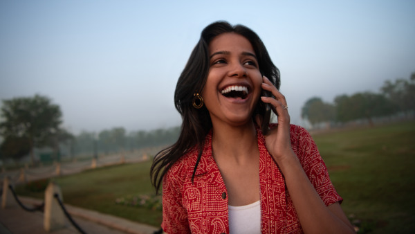 Woman taking in a mobile phone.