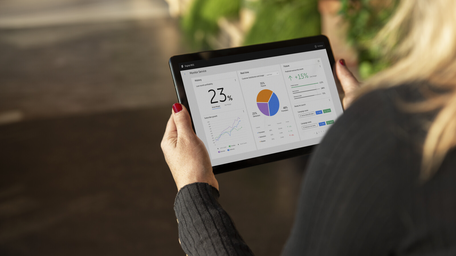 Person holding a tablet displaying a graph.