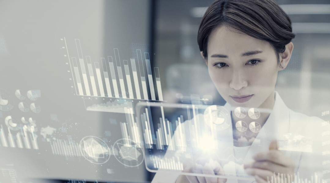 Person uses digital interface with charts and diagrams.