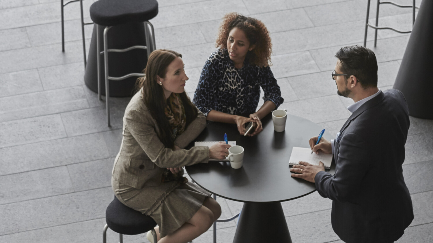 Colleagues discussing over a coffee.