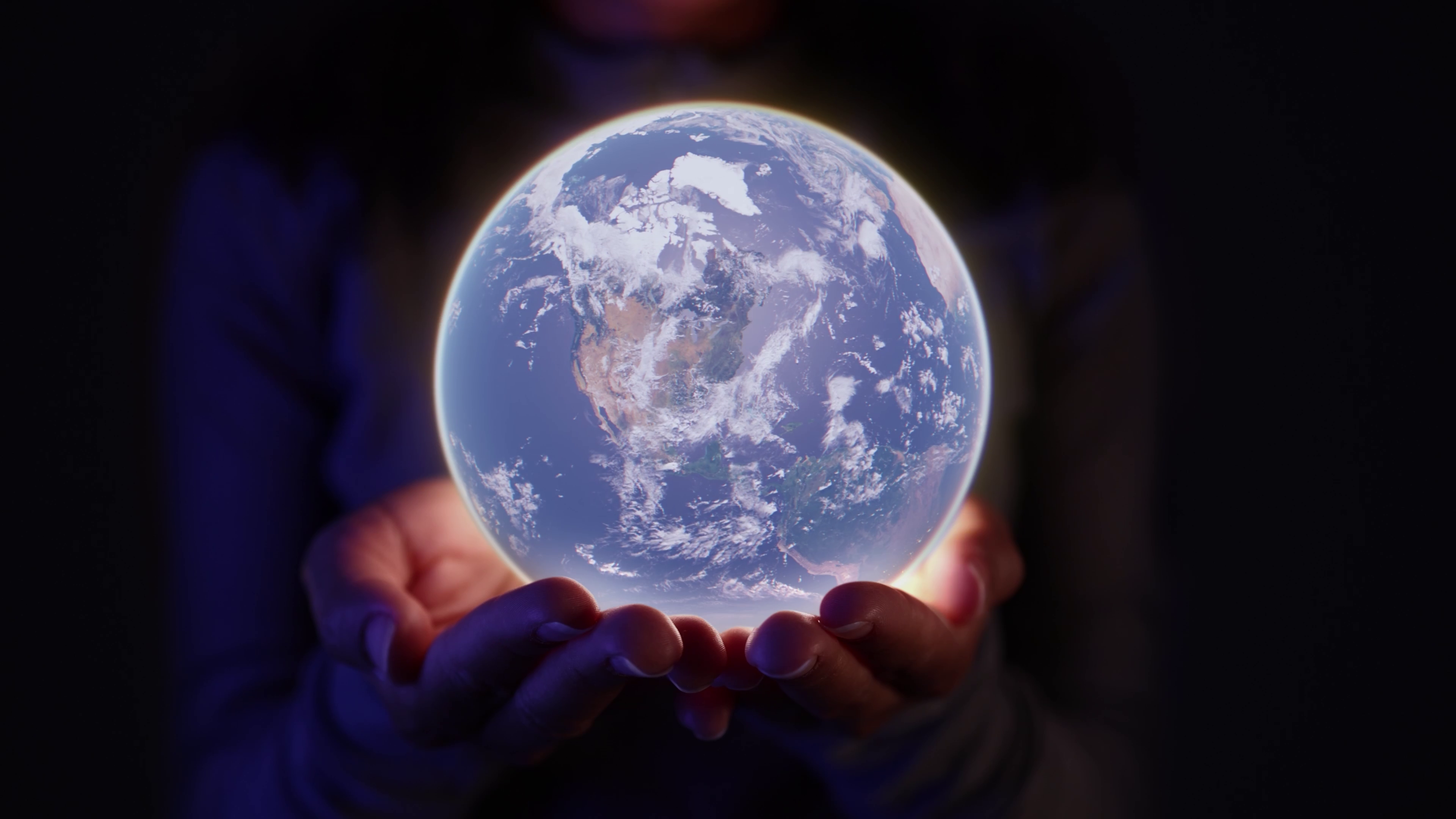 Hands holding a glowing earth globe.
