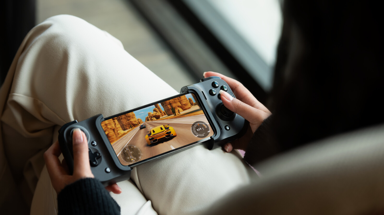 Gaming woman sits and plays game on phone