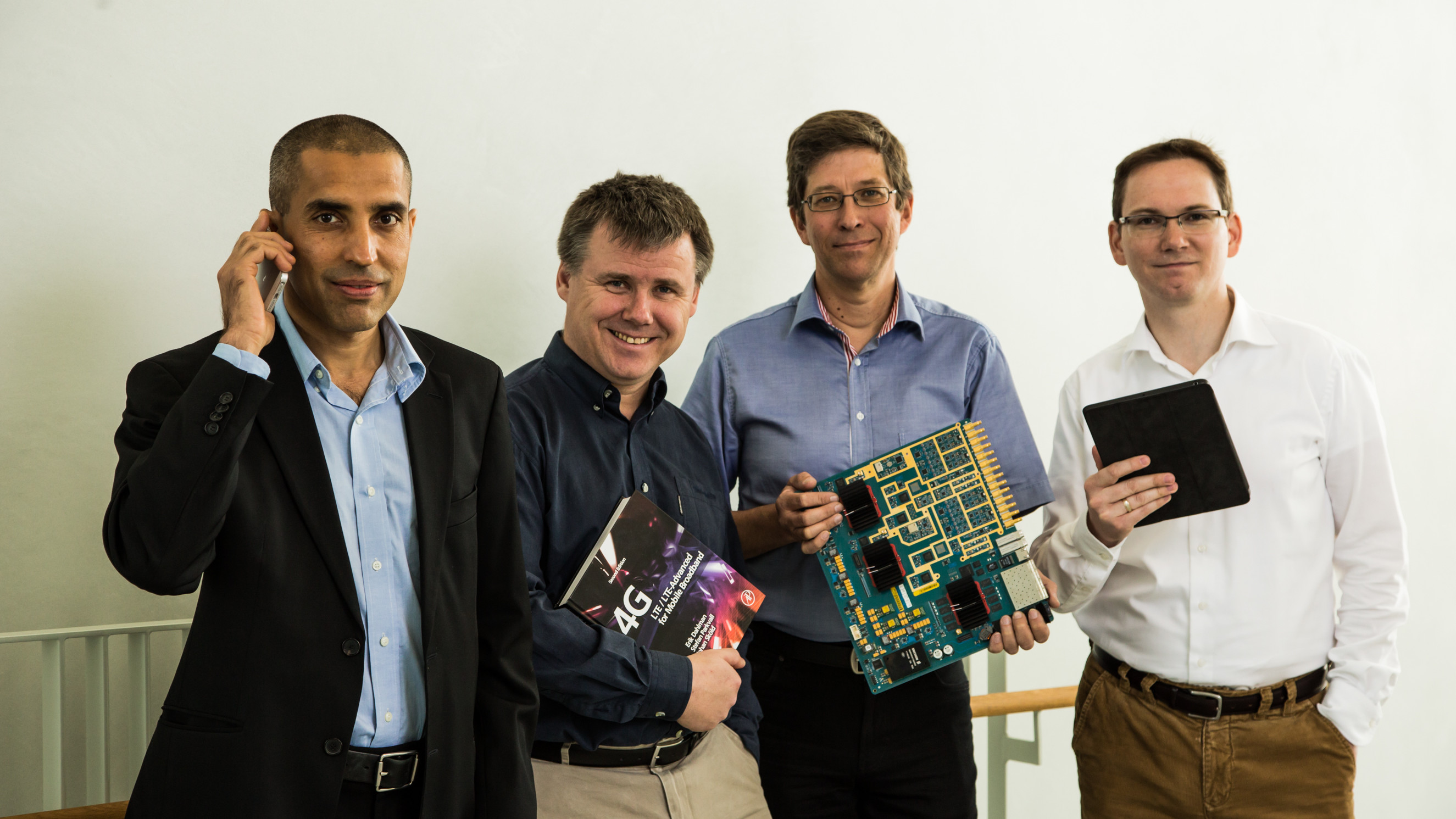 group of people sitting at computers at a long table