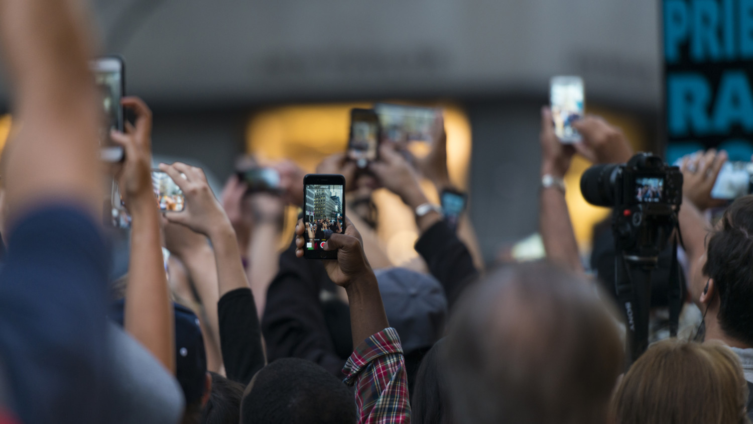Crowd taking photos with smartphones