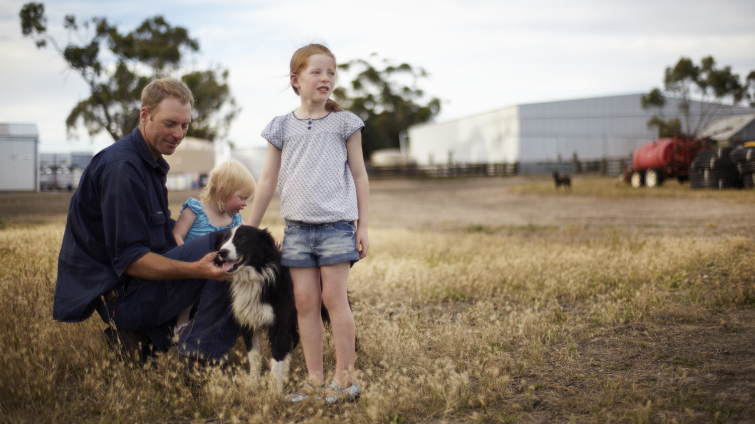 A man, two children and a dog