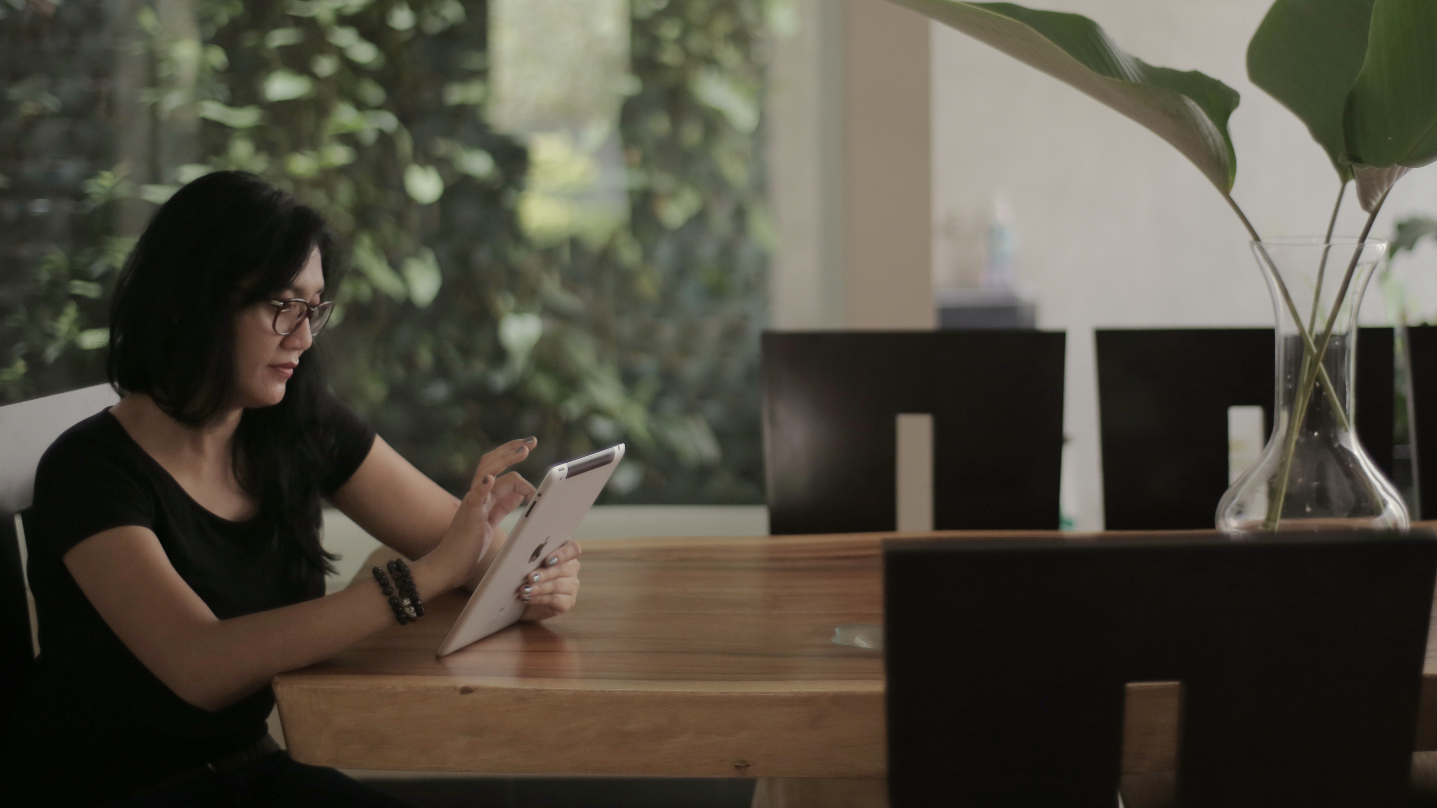 Woman sitting using tablet