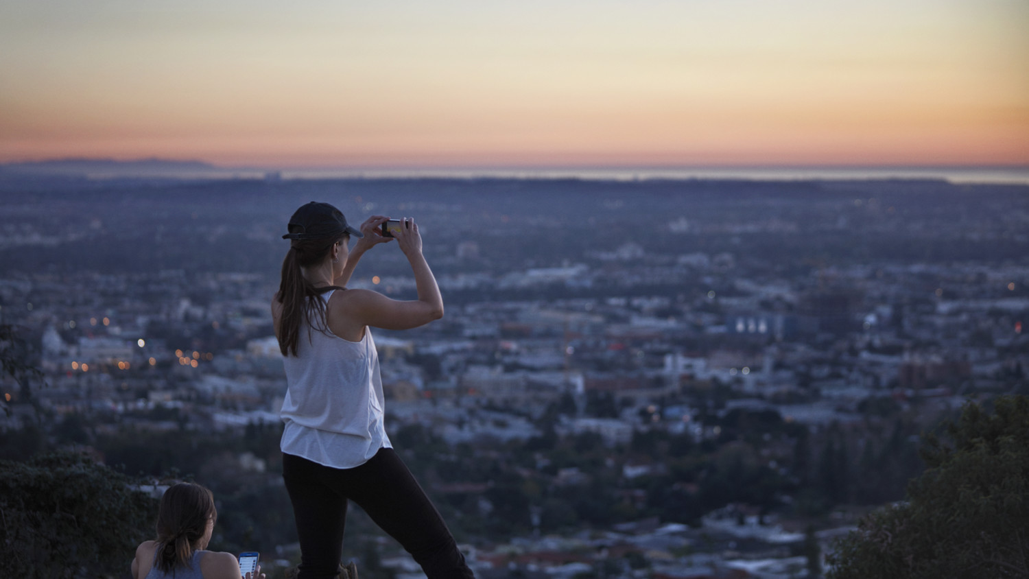 Woman taking photo of city view.