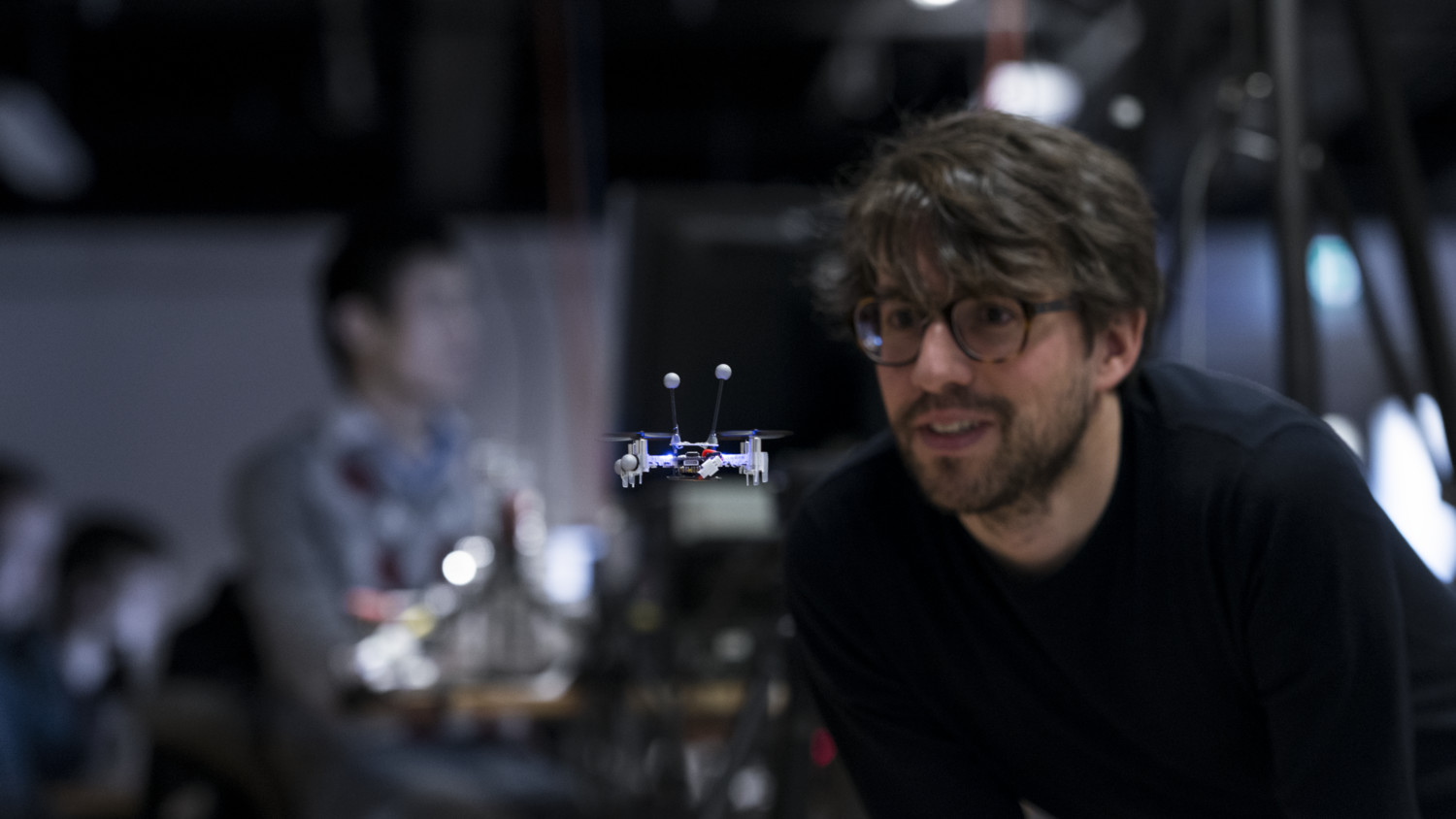 Man looking at a small drone