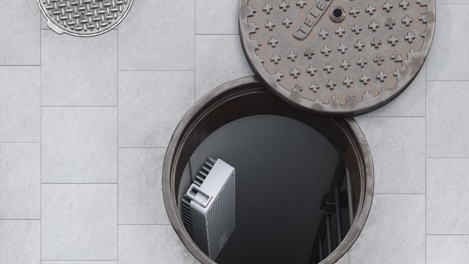 Street manhole with radio antenna mounted on the wall.