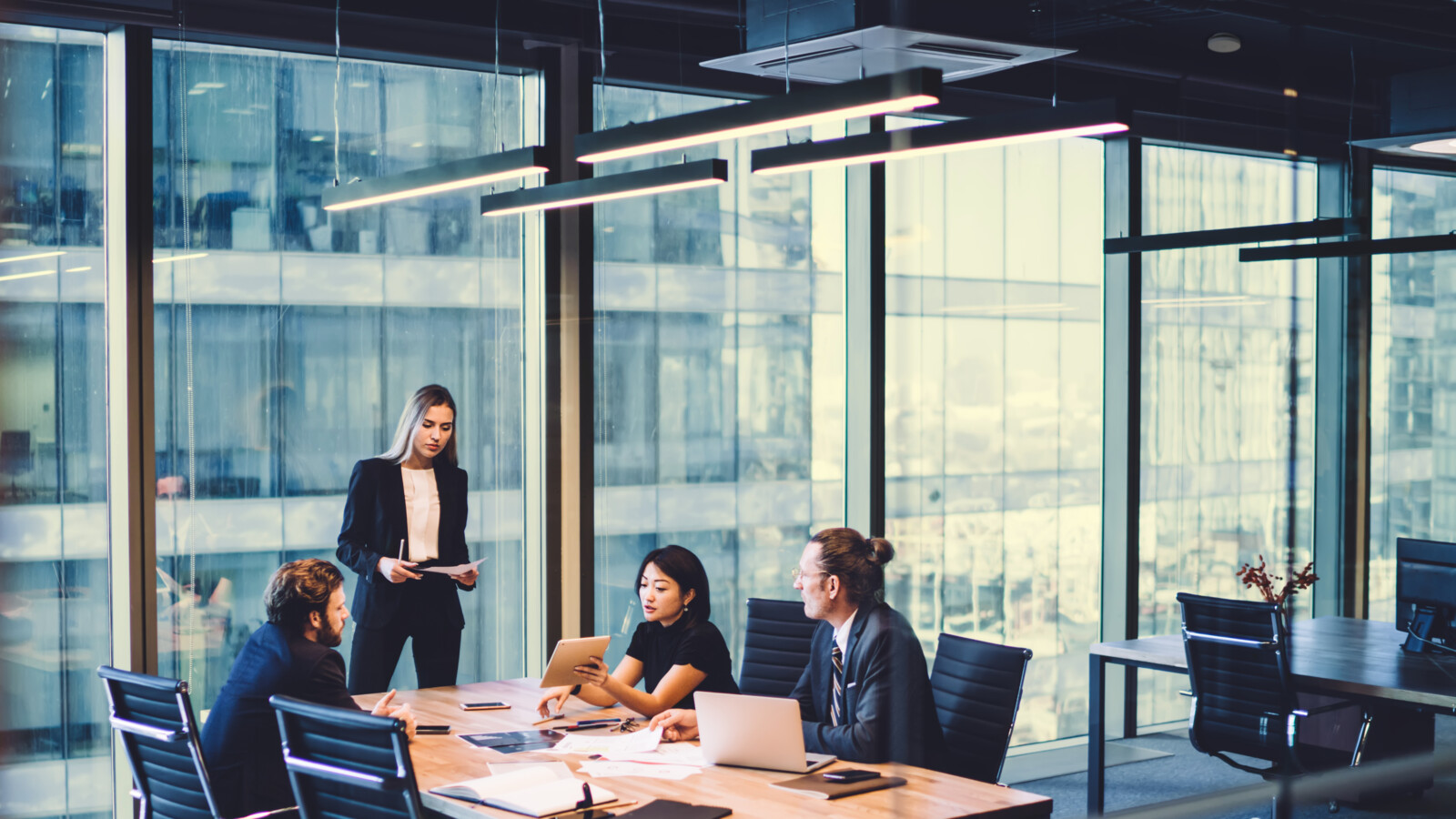 Colleagues in having a meeting in an open office space.