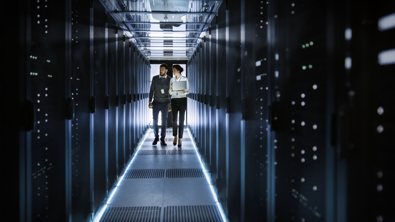 Two people working in a secure server room.