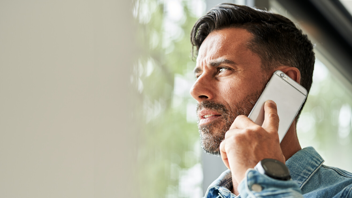 A man taking a Voice over LTE (VoLTE) call on a smartphone.