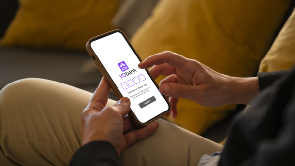 Skier looking at his mobile phone in a gondola lift.