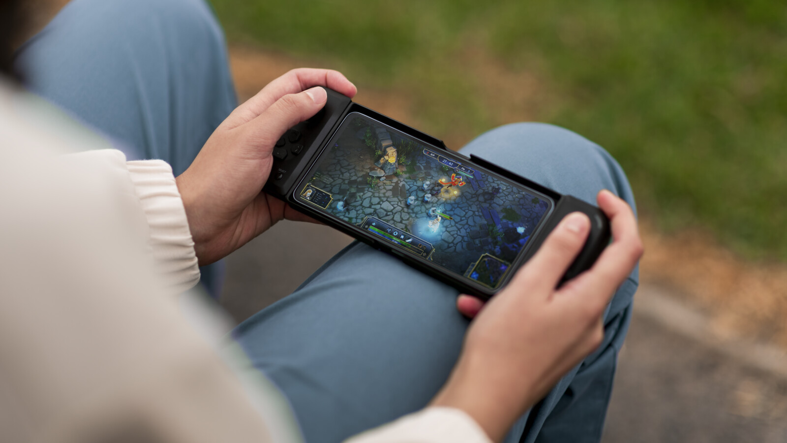 A boy playing mobile cloud games outdoors on a van.