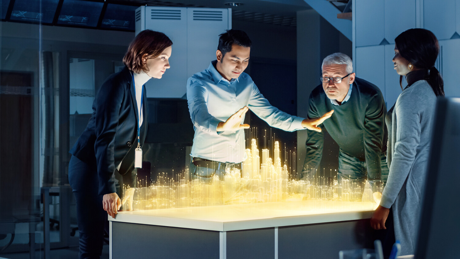 Persons discussing around a holographic model of a city.