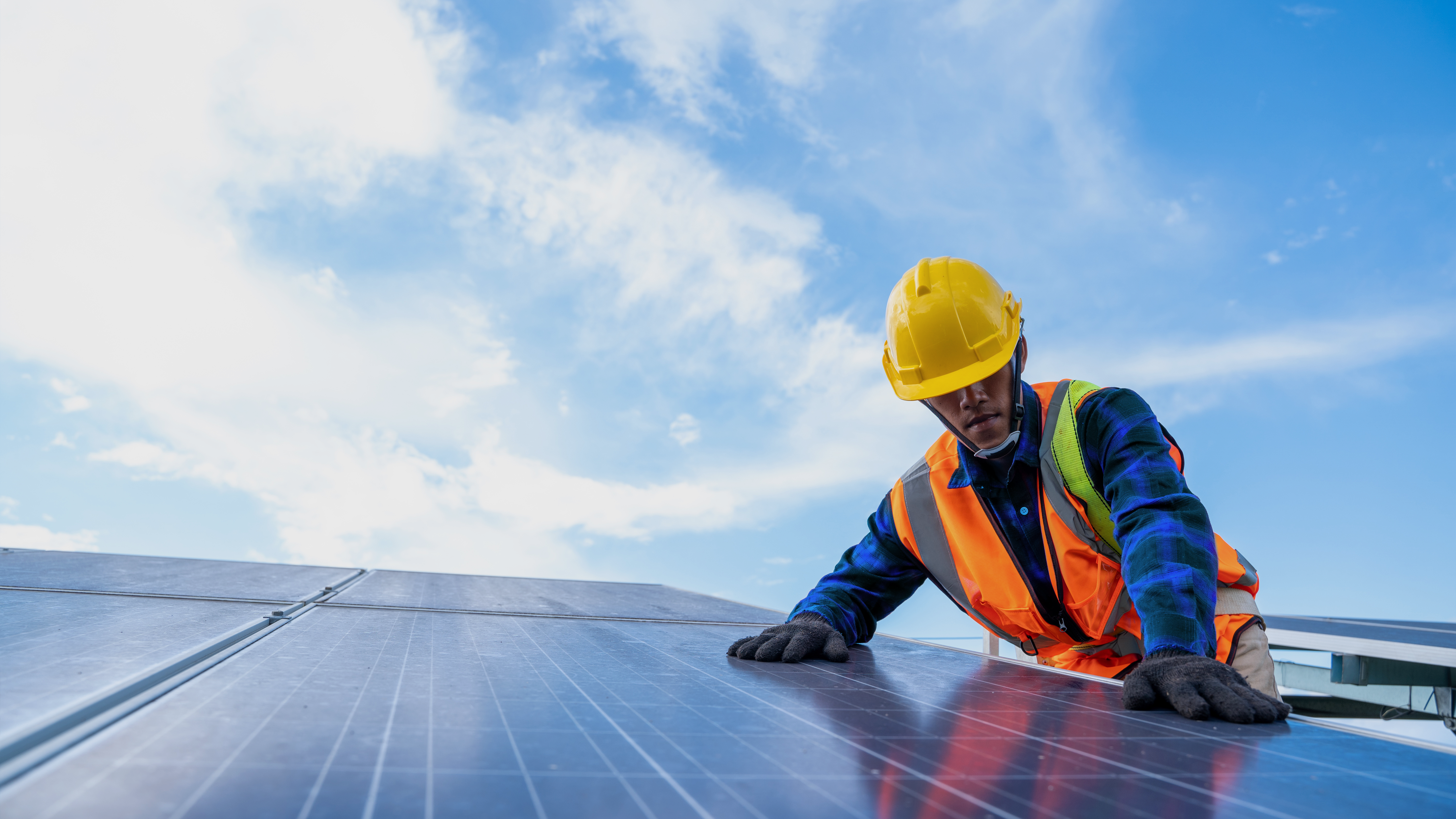 Electrician replacing a solar panel at a solar power plant.