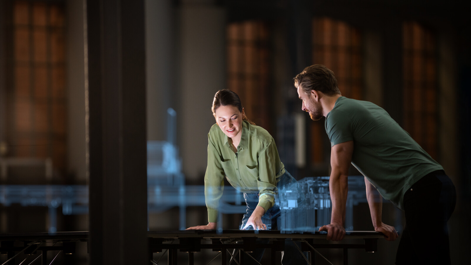 Colleagues discussing 5G industry project using a holographic model of a digital twin