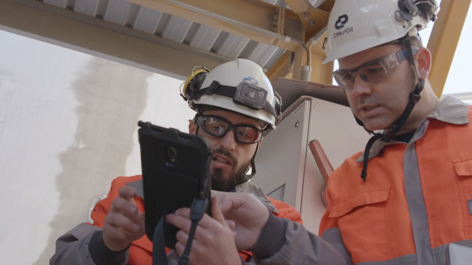 Experts reviewing the site status on the tablet